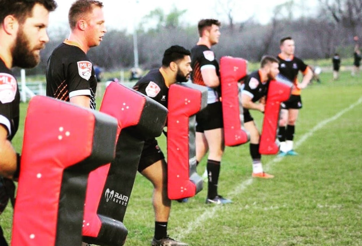 Ram Rugby Double Wedge Hit Shield in black and red with durable PVC and high-density foam for tackle practice impact absorption