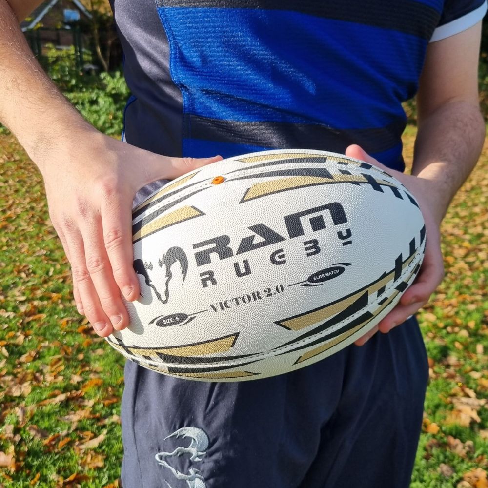 Ram Rugby Victor 2.0 Elite Match Rugby Ball showing durable 4-ply polycotton and rubber construction with 3D grip texture