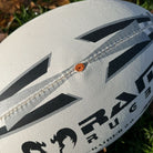 Close-up of Ram Rugby Raider 2.0 durable rugby match ball with textured rubber surface and valve-in-seam design for training and games